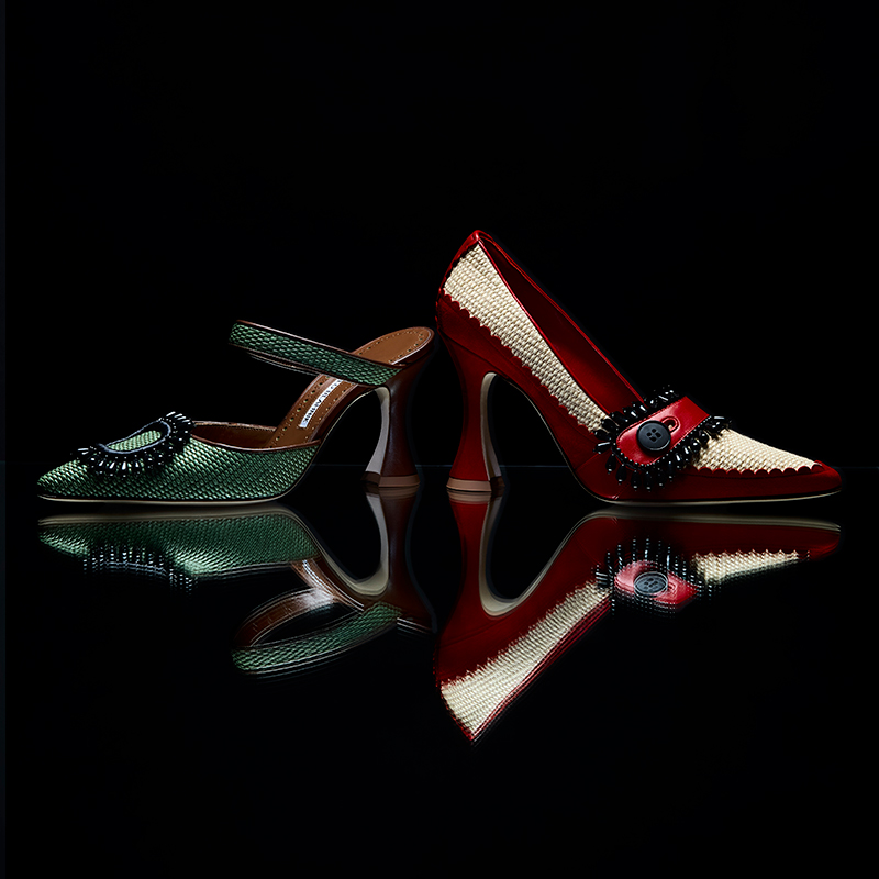 Image of two women's raffia shoes in red and green.