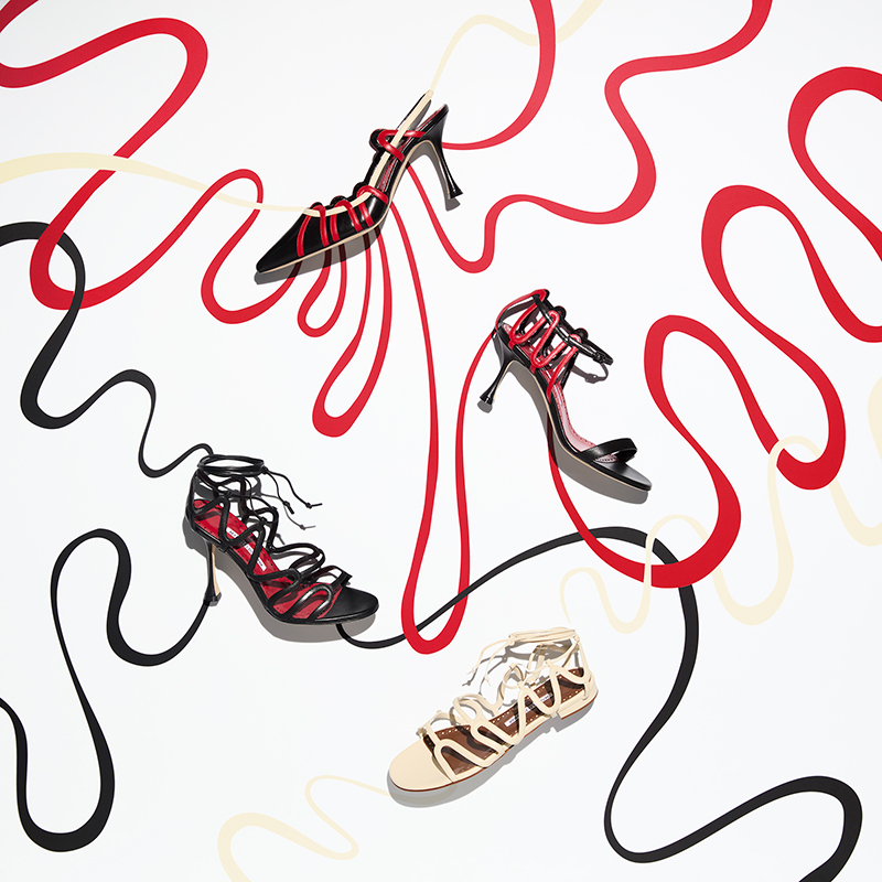 Image of black, cream and red women's shoes on a white background.