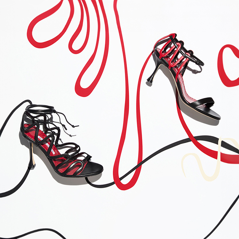 Image of black, cream and red women's shoes on a white background.