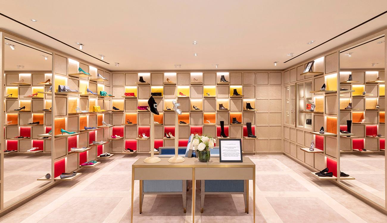 The inside of the Ocean Centre store, which has a table and surrounding walls filled with shelves of shoes. 