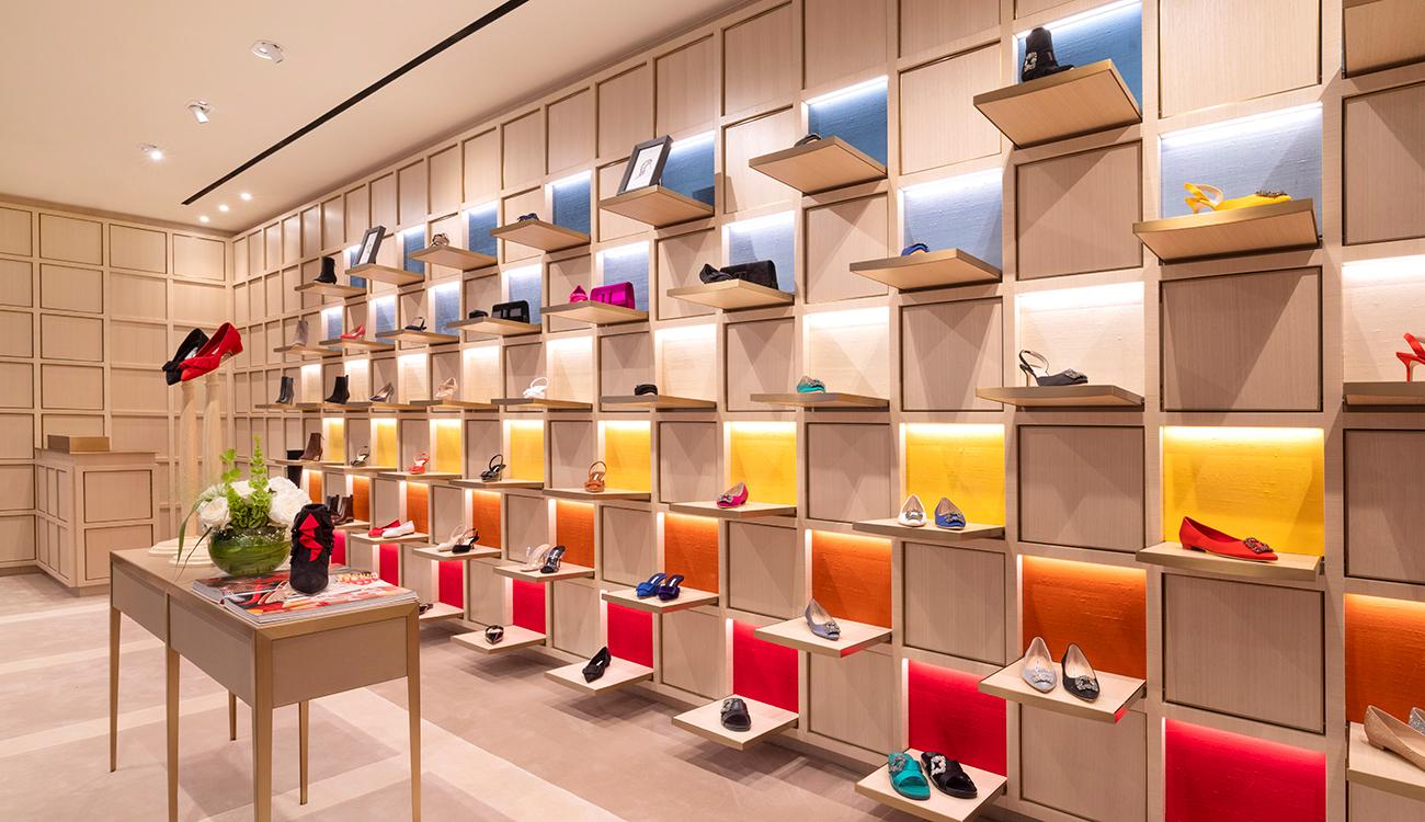 The inside of the Pacific Place store with shelves of shoes and a table in the centre of the space.